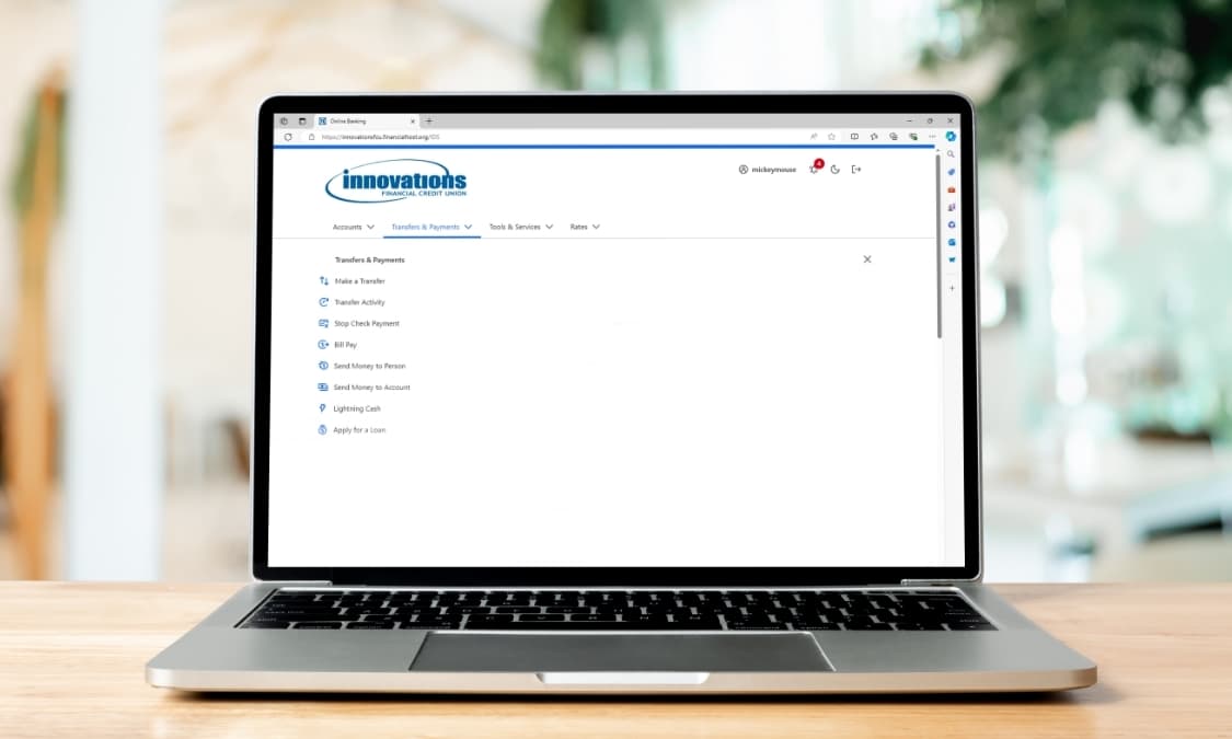 Screenshot of the Bill Pay screen on a laptop resting on a table.