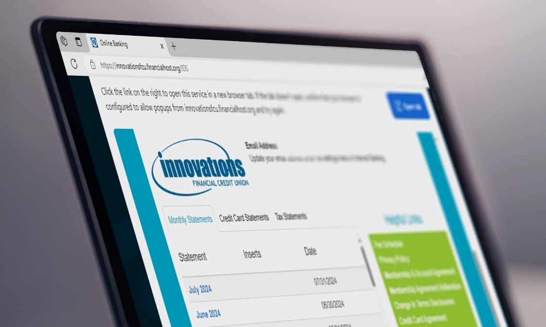 A laptop showing the Online Statements portal.