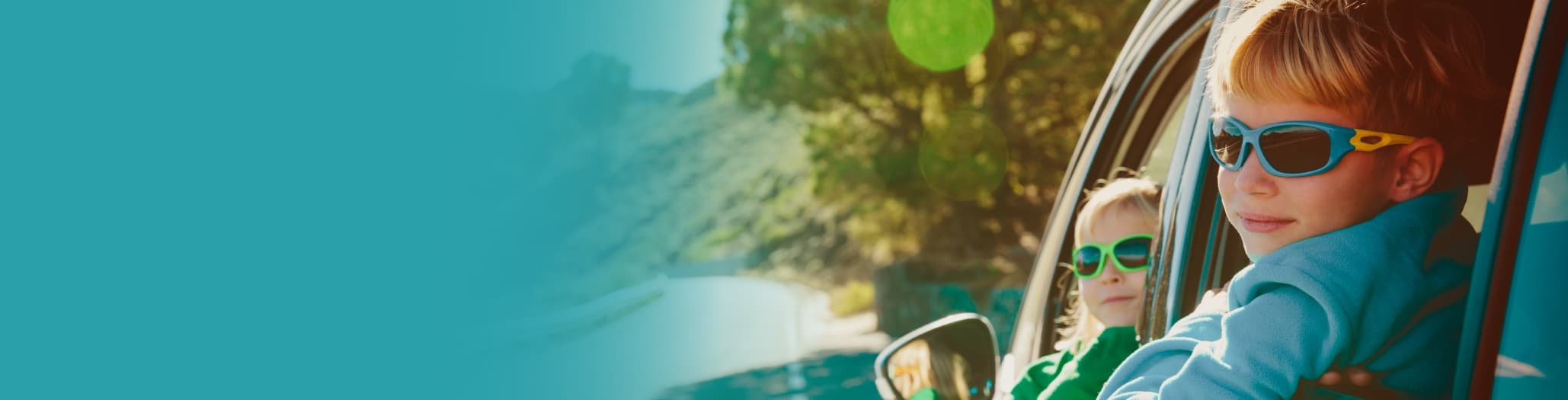 Two young children looking out the windows of a car.